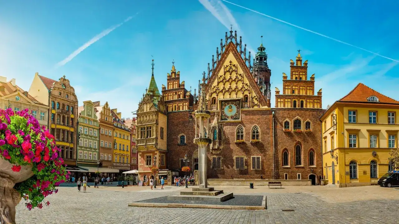 Rynek we Wrocławiu, idealne miejsce na city break z Wrocławia. Kolorowe kamienice, zabytkowy ratusz i kwitnące kwiaty tworzą malowniczy widok.
