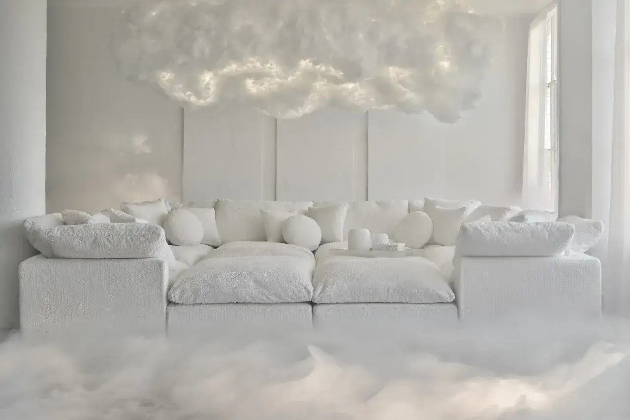 Sofá blanco etéreo con cojines mullidos, suspendido entre nubes luminosas. Un sueño de **pantone 2026** hecho realidad.