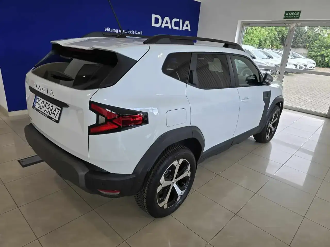 Nowa, biała Dacia Duster z czarnymi dodatkami, gotowa na przygodę.