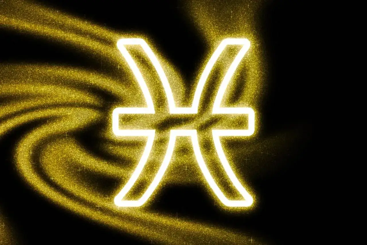 Symbol Ryb, 16 stycznia znak zodiaku, otoczony złotym pyłem i światłem.