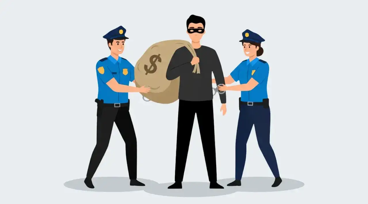 Dwóch policjantów aresztuje złodzieja z workiem pieniędzy.