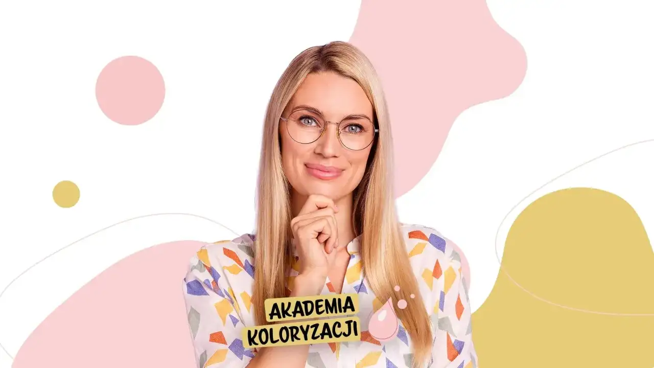 Kobieta z chłodnym blondem i okularami, z ręką na podbródku, uśmiecha się. Na jej bluzce widnieje napis "AKADEMIA KOLORYZACJI".