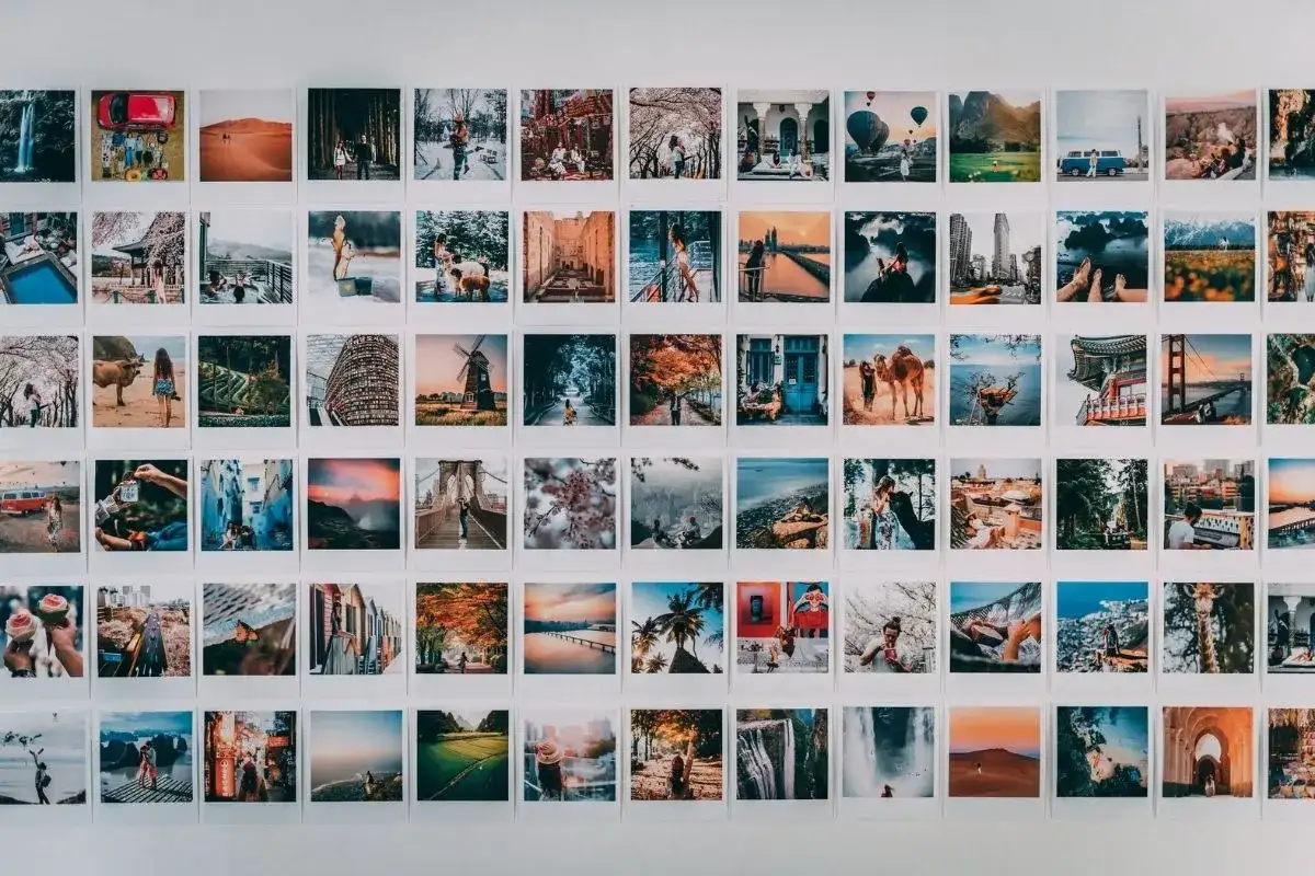 Inspiracja do tego, jak zrobić kolaż zdjęć na komputerze: ściana ozdobiona mnóstwem małych, podróżniczych fotografii.