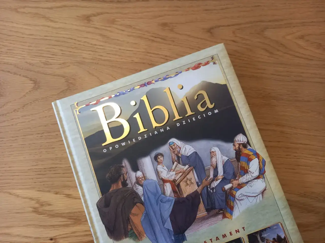 Okładka Biblii opowiedzianej dzieciom, z ilustracją sceny biblijnej i złotym napisem. Idealna do czytania opowieści biblijnych dla dzieci.