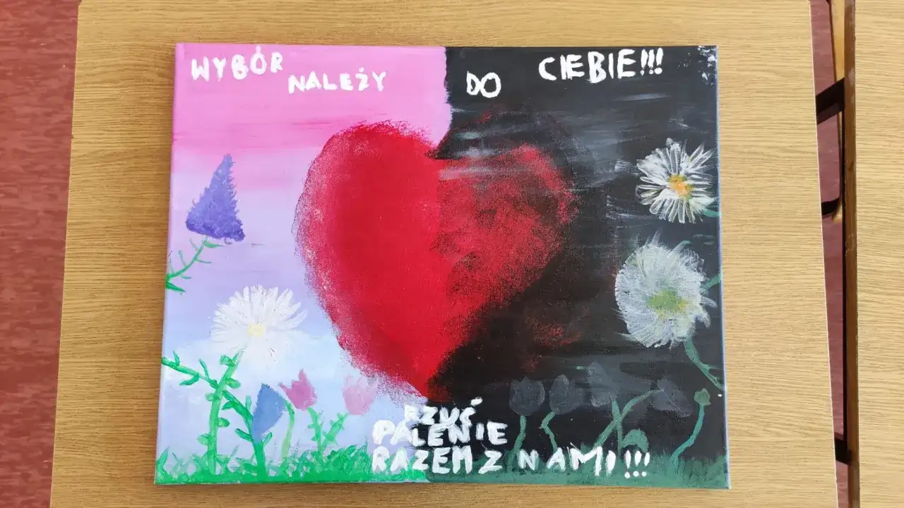 Praca plastyczna: serce podzielone na jasną i ciemną stronę, z napisem "Wybór należy do Ciebie!!! Rzuć palenie razem z nami!!!".