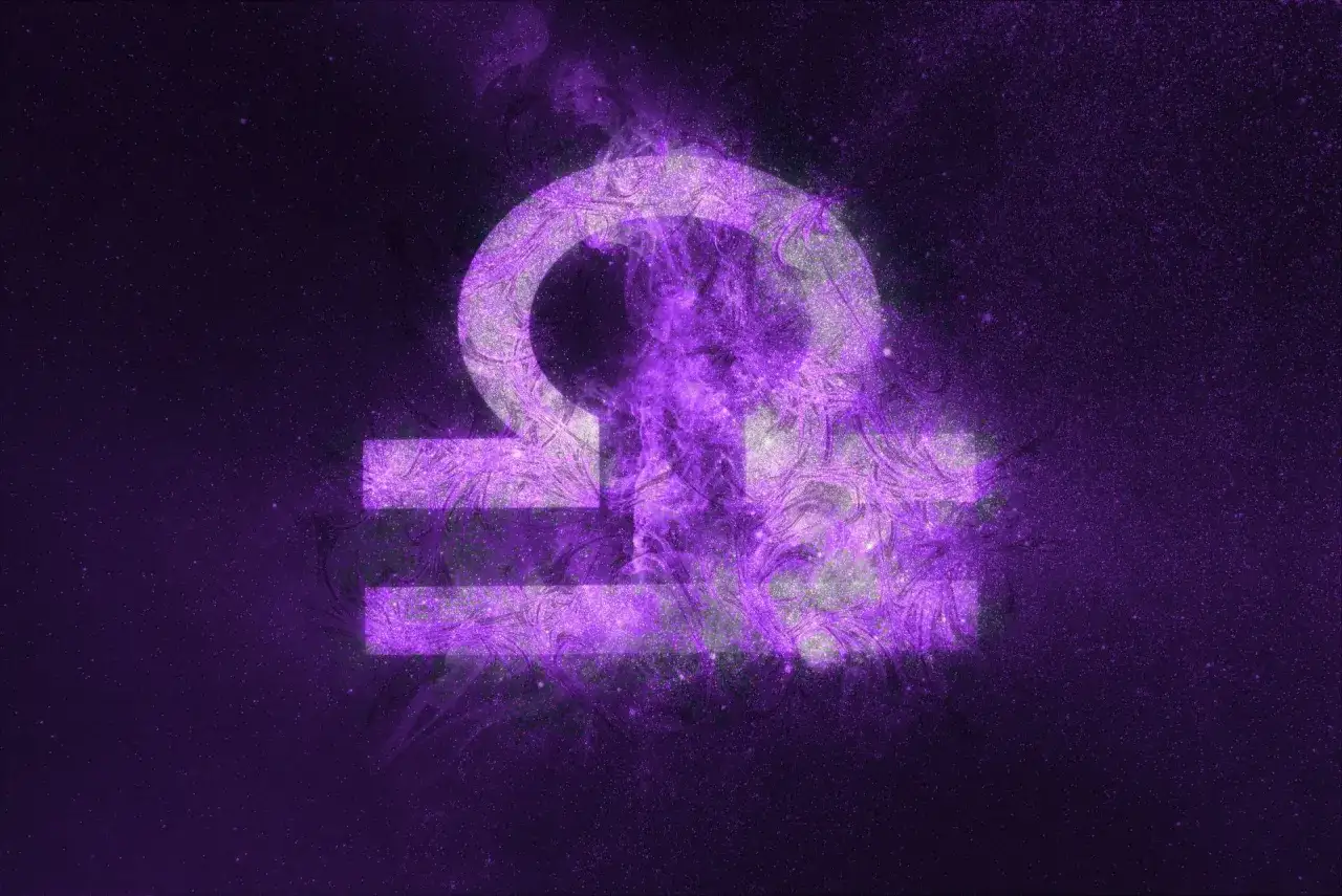 Symbol Wagi, 17 września znak zodiaku, w fioletowej mgławicy kosmicznej.