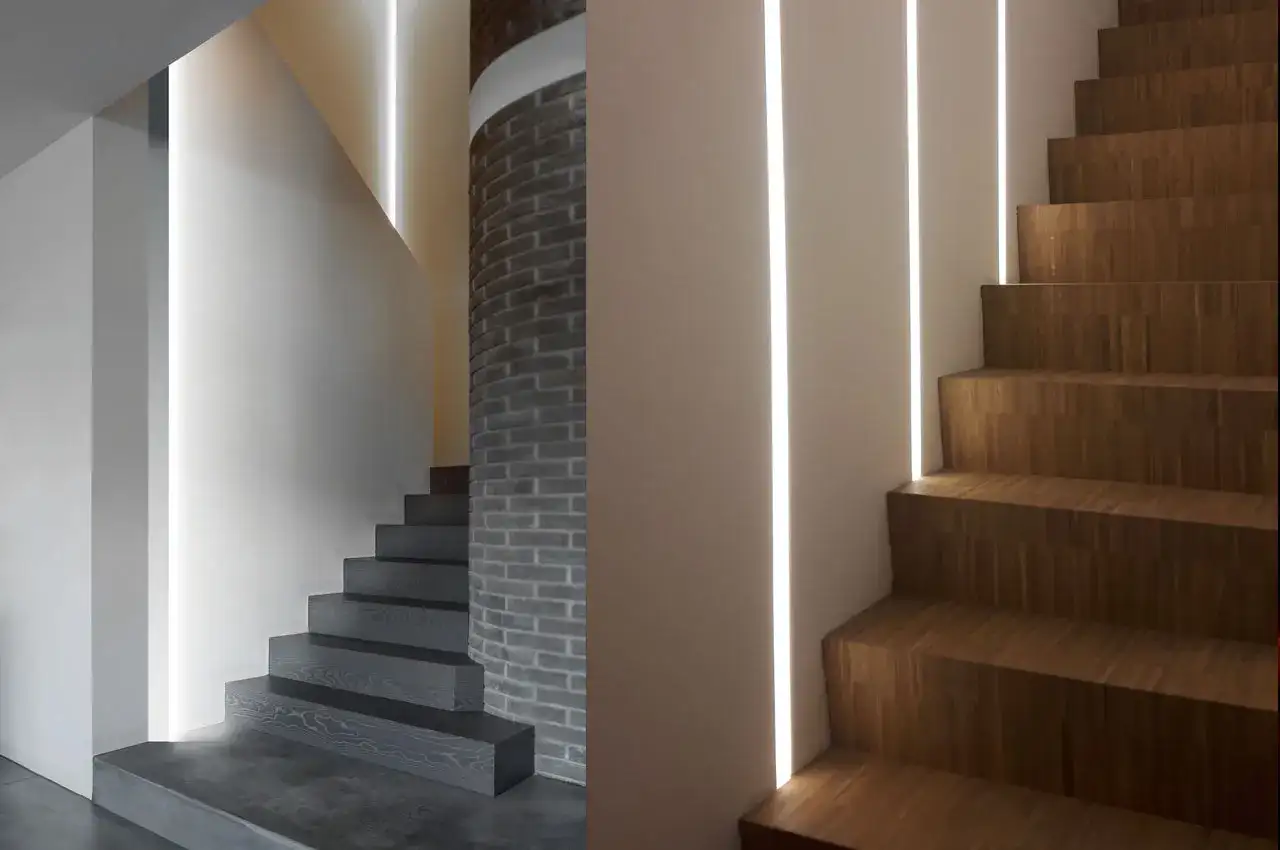 Nowoczesne schody z drewnianymi stopniami i szarymi stopniami, oświetlone pionowymi ledami w ścianie przy schodach.