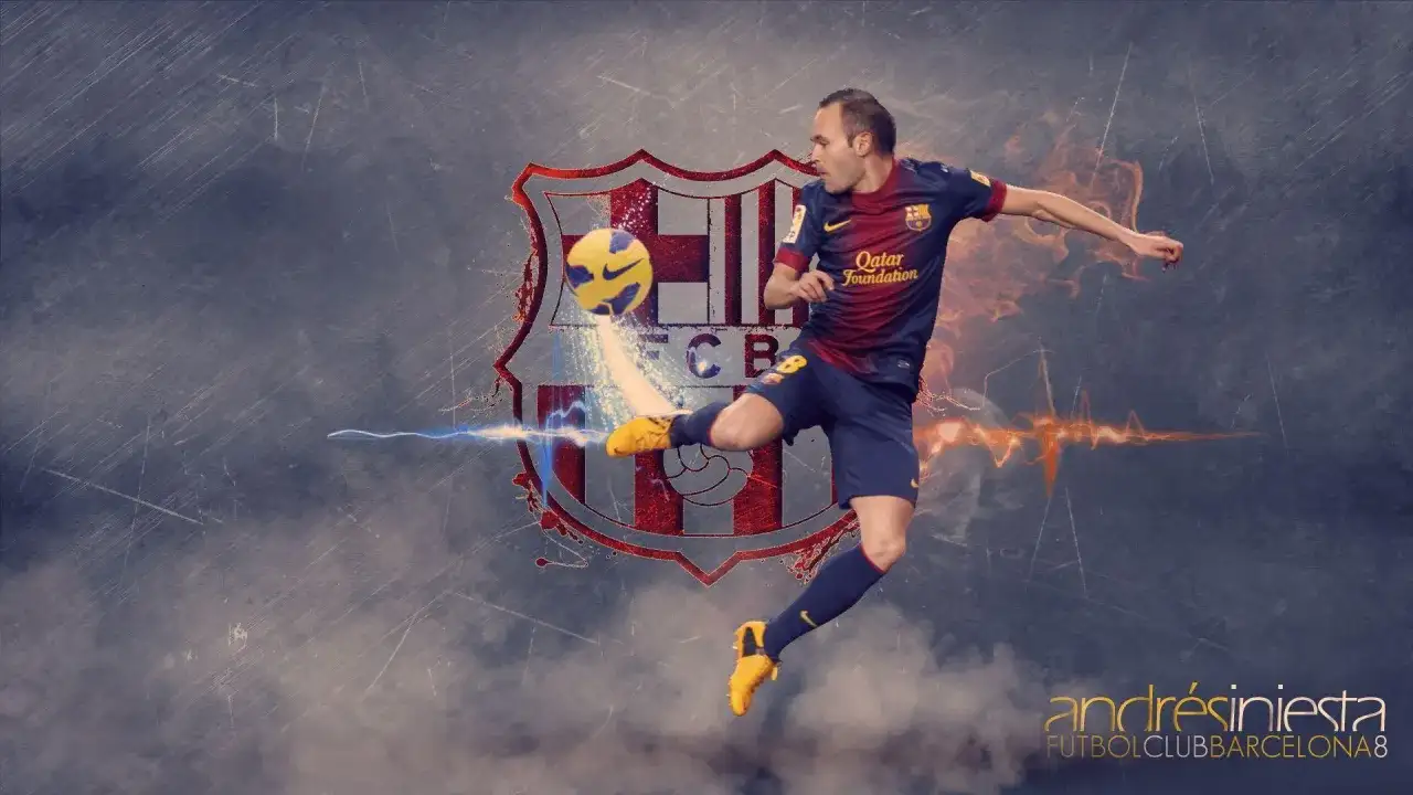 Andrés Iniesta w skoku kopie piłkę na tle herbu FC Barcelony.