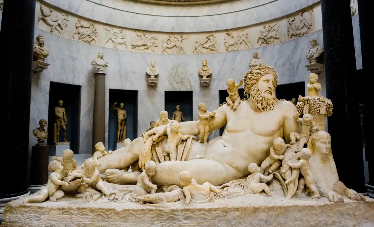 Marmorskulptur eines liegenden Mannes mit Putten und einer Sphinx.