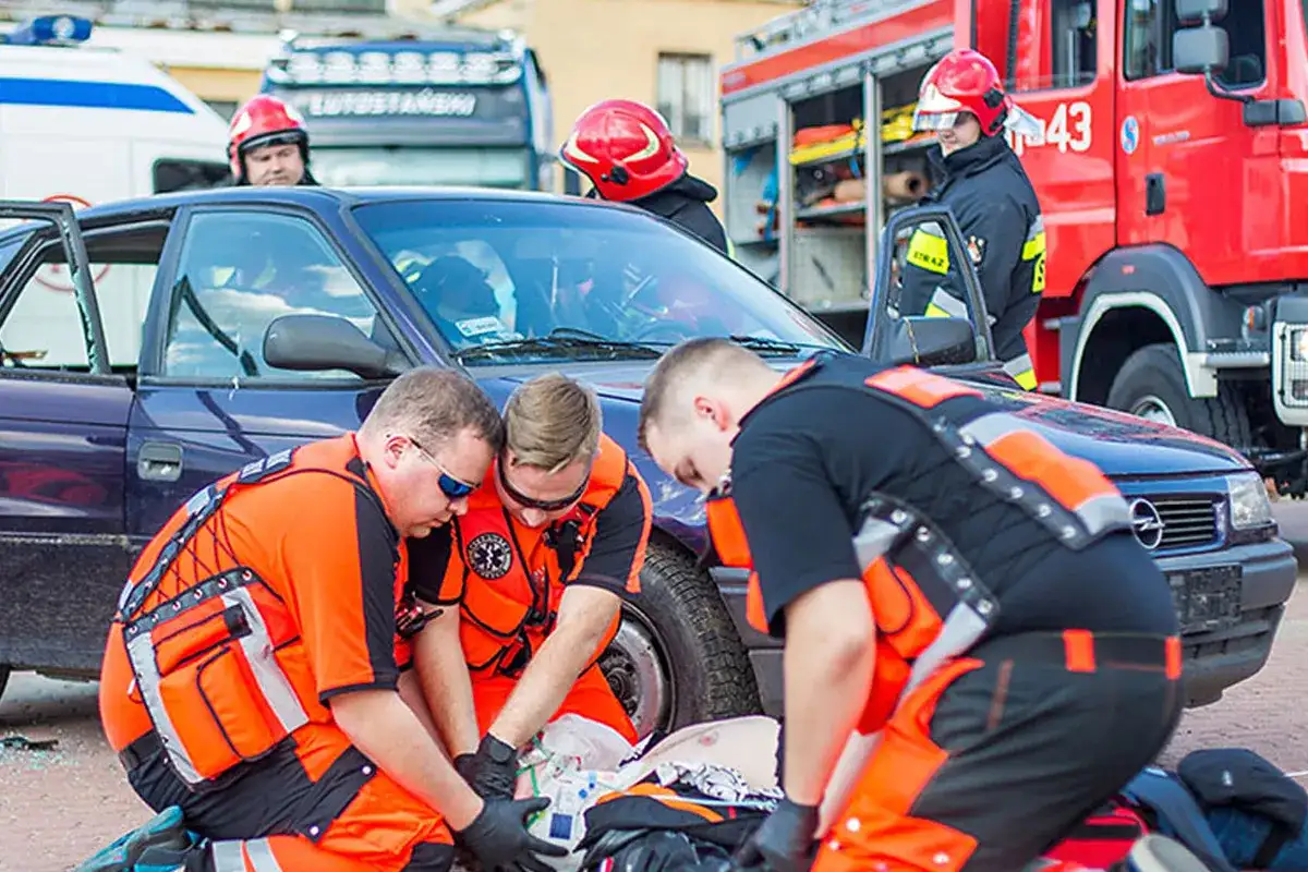 Ratownicy medyczni ćwiczą udzielanie pomocy poszkodowanemu po wypadku samochodowym. To jak wygląda egzamin KPP w praktyce.