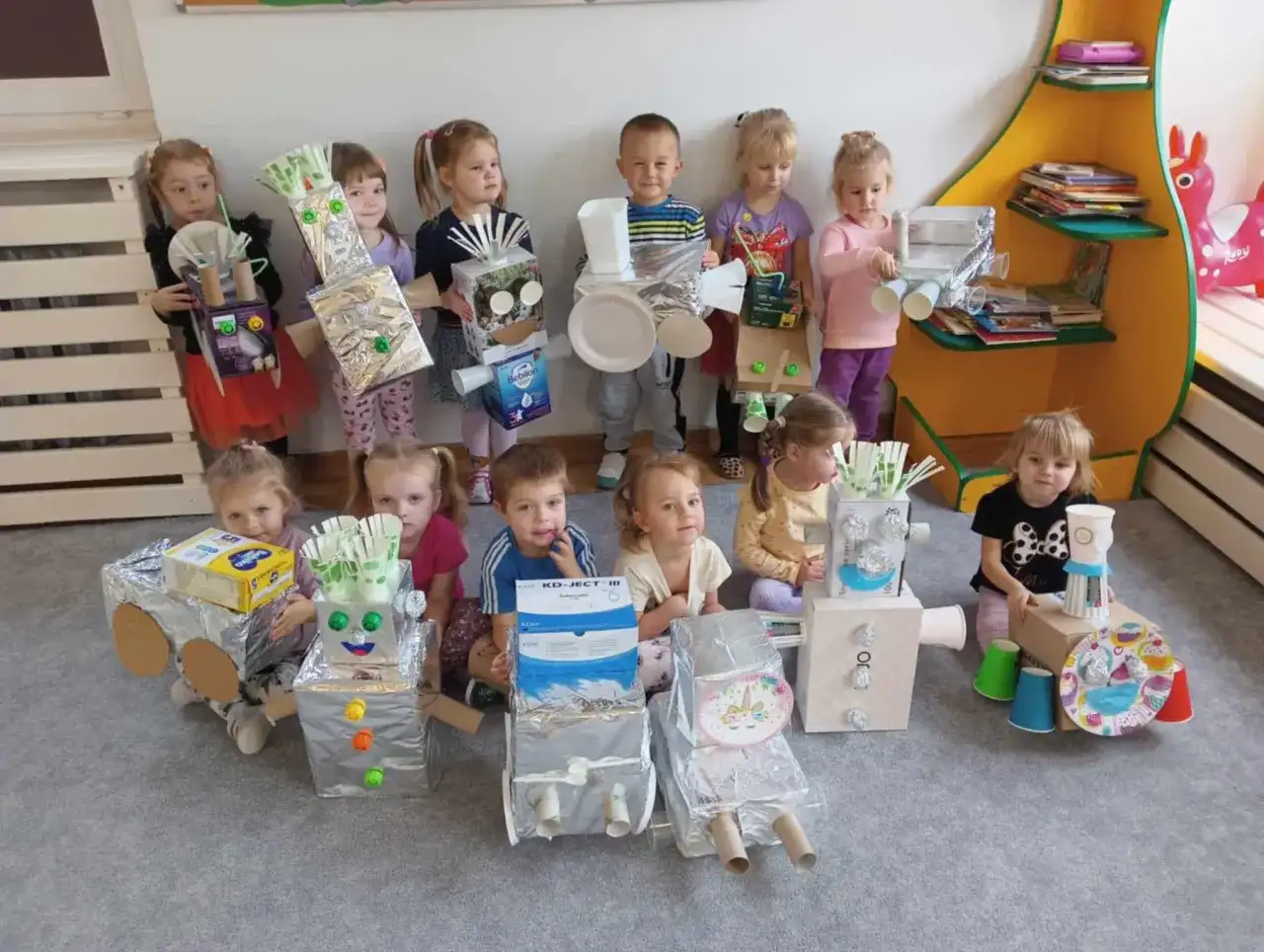 Dzieci prezentują swoje roboty z recyklingu, wspaniałe zabawy dla przedszkolaków.