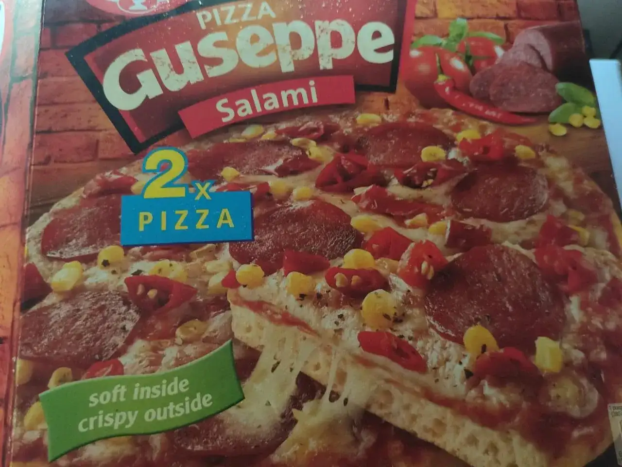 Pizza Giuseppe Salami z kukurydzą i papryczką chili, z napisem "2x Pizza".