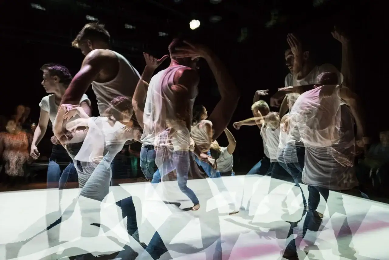 Dynamiczne ruchy tancerzy na scenie. Krakowski teatr tańca w ruchu, uchwycony w wielokrotnej ekspozycji.