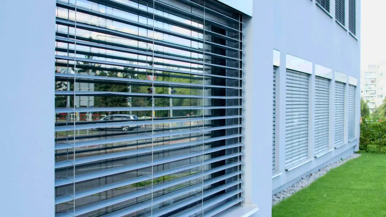 Nowoczesne rolety zewnętrzne balkonowe w bloku zapewniają prywatność i ochronę przed słońcem.