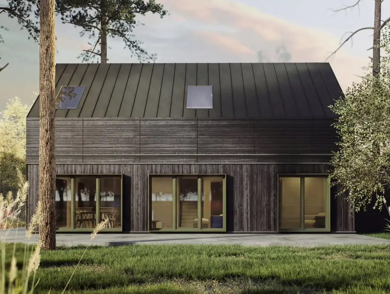 Nowoczesny dom z drewna i metalu, otoczony drzewami. Zastanawiasz się, ile kosztuje budowa domu z gotowych elementów?