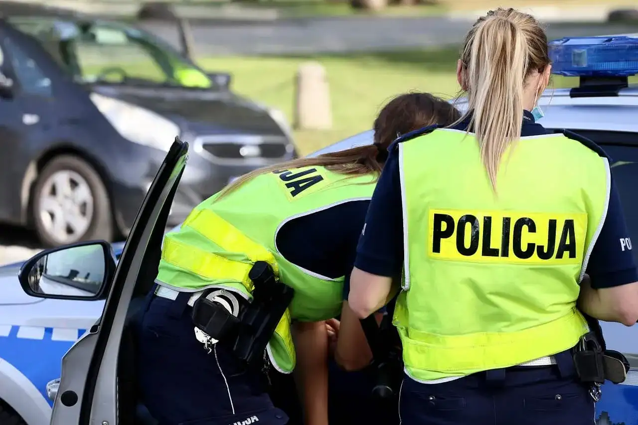 Policjantki w kamizelkach odblaskowych przy radiowozie. Czy trzeba mieć przy sobie OC? To pytanie zadaje sobie wielu kierowców.