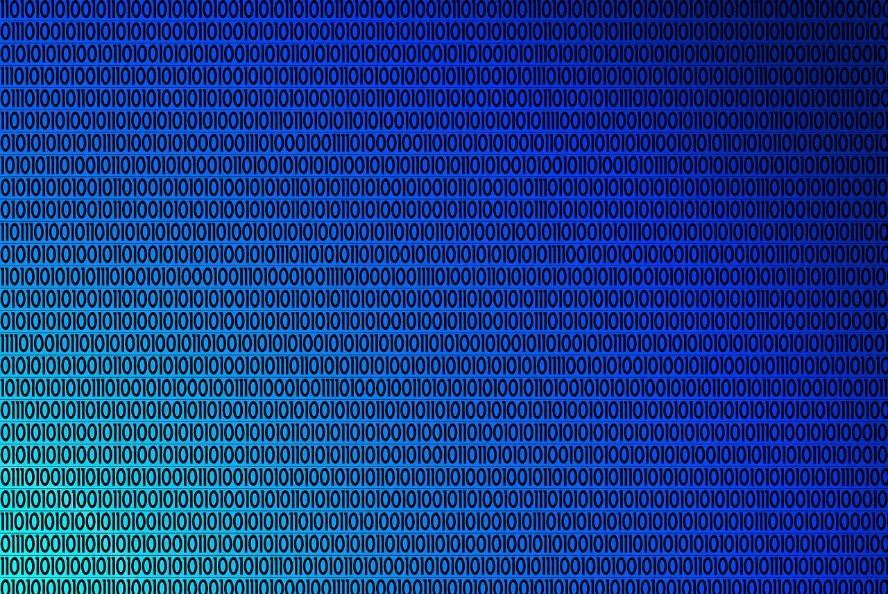 Tło z cyframi 0 i 1, tworzące wzór. To jest właśnie system binarny dwójkowy, język komputerów.