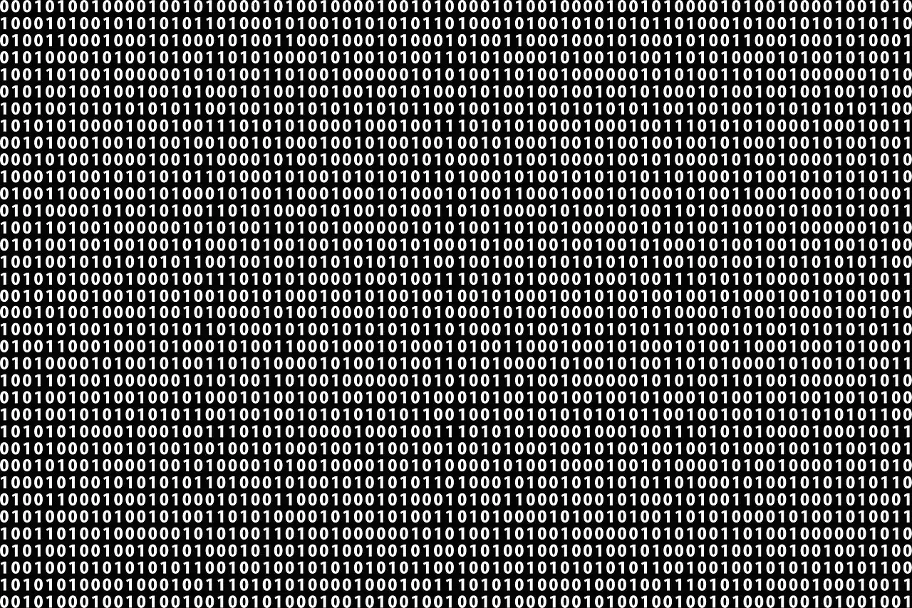 Tło z białych cyfr 0 i 1 na czarnym tle, tworzące wzór kodu binarnego.