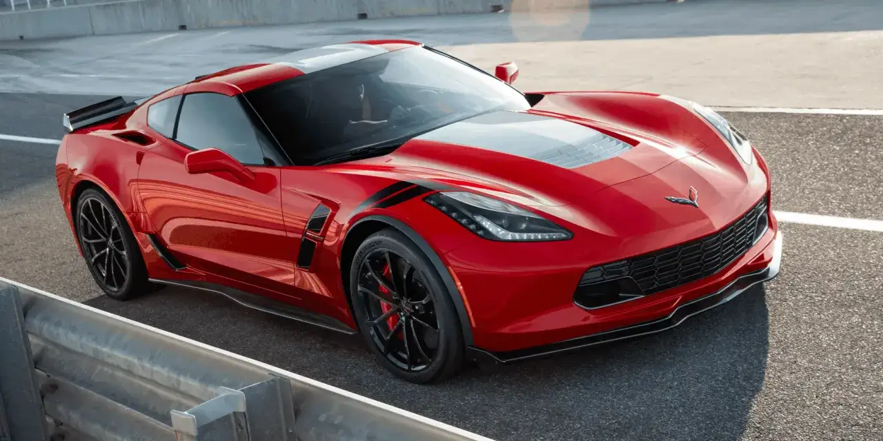 Czerwony Chevrolet Corvette C7 na torze. Sprawdź aktualną corvette c7 cena i specyfikację tego sportowego auta.