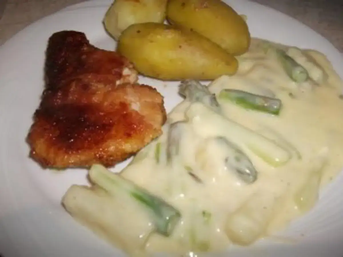 Gebratene Schnitzel mit Salzkartoffeln und Spargel in Sauce Hollandaise. Ein Klassiker, der zeigt, was gut zu Spargel passt.