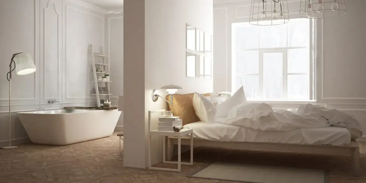 Chambre moderne avec baignoire &icirc;lot, lit douillet et grande fen&ecirc;tre. Un espace de vie o&ugrave; le confort d'une chambre rencontre la d&eacute;tente d'une wet room.
