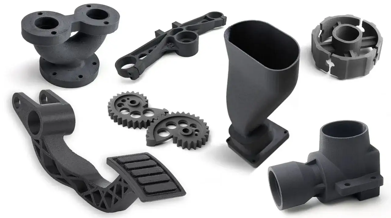 A collection of intricate, dark gray parts showcasing the versatility of automotive 3d printing, including gears, a pedal, and complex structural components.