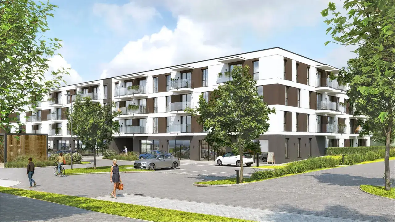 Nowoczesne osiedle mieszkaniowe, przypominające spokojną **koncertową dolinę**, z zielenią i miejscami parkingowymi.