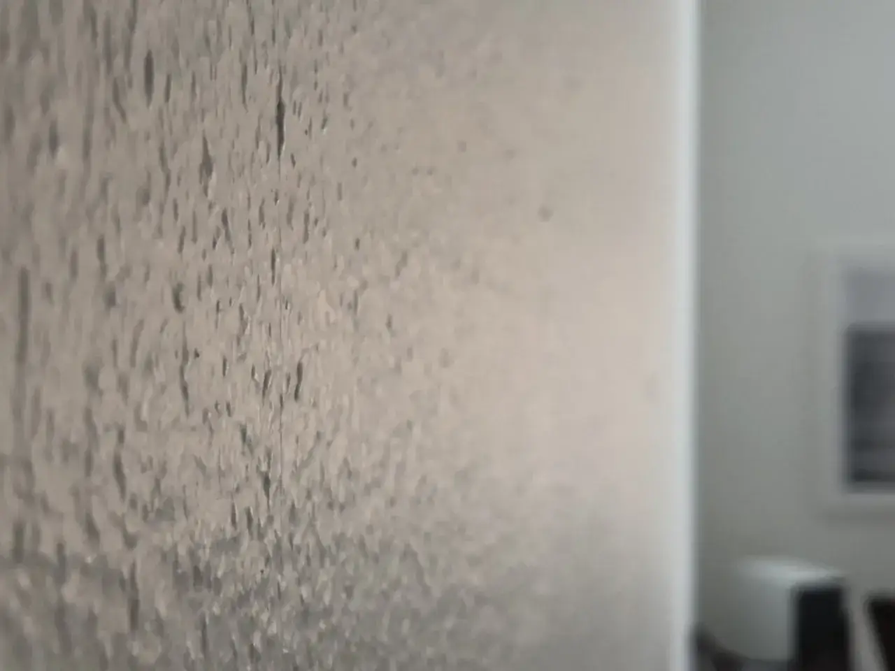 En vägg med en grov, ojämn yta som kan ha bredspacklats för att skapa en strukturtapet.