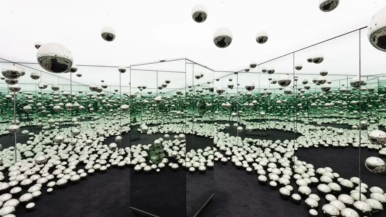 Infinity room installation at the Rubell Museum Miami, filled with mirrored spheres on the floor and suspended from the ceiling.