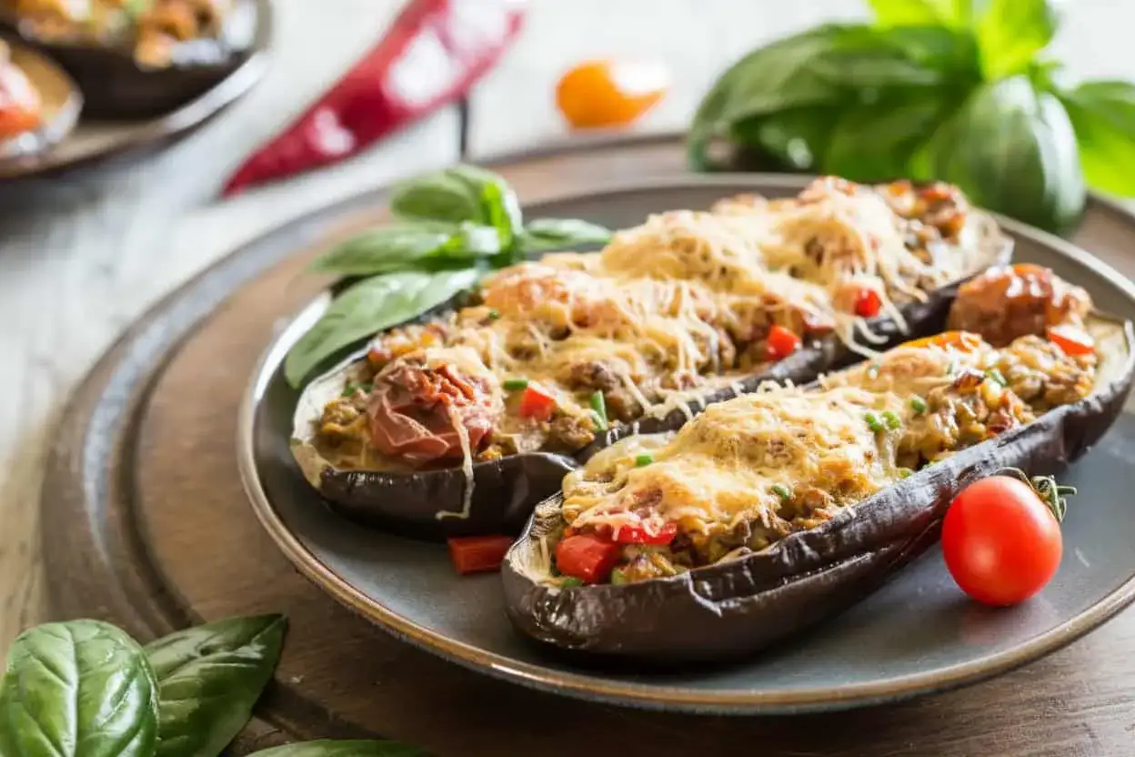 Berenjenas rellenas de atún gratinadas, con tomate y albahaca fresca. Un plato delicioso y fácil de preparar.