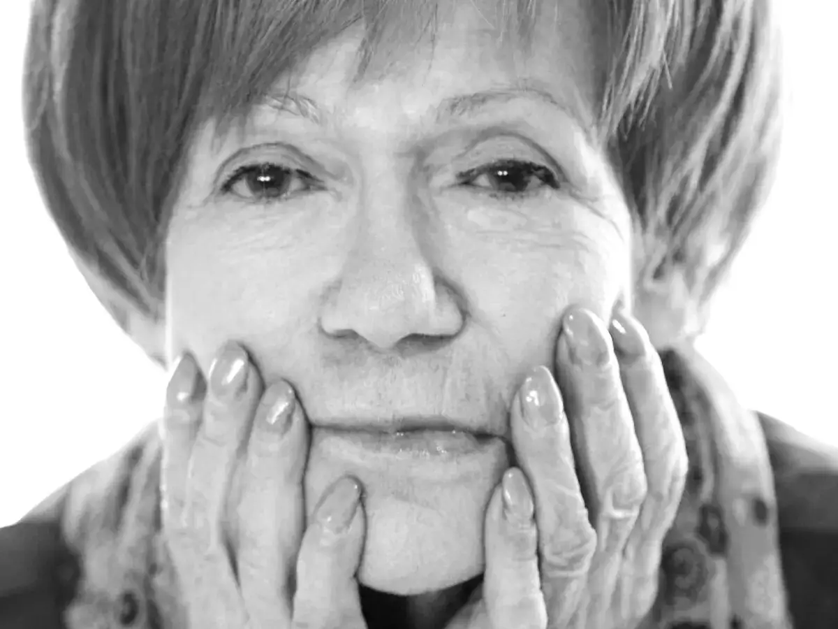 Portret Marii Czubaszek, zamyślonej, z dłońmi opartymi o policzki. Jej spojrzenie przywodzi na myśl jej słynne maria czubaszek cytaty.