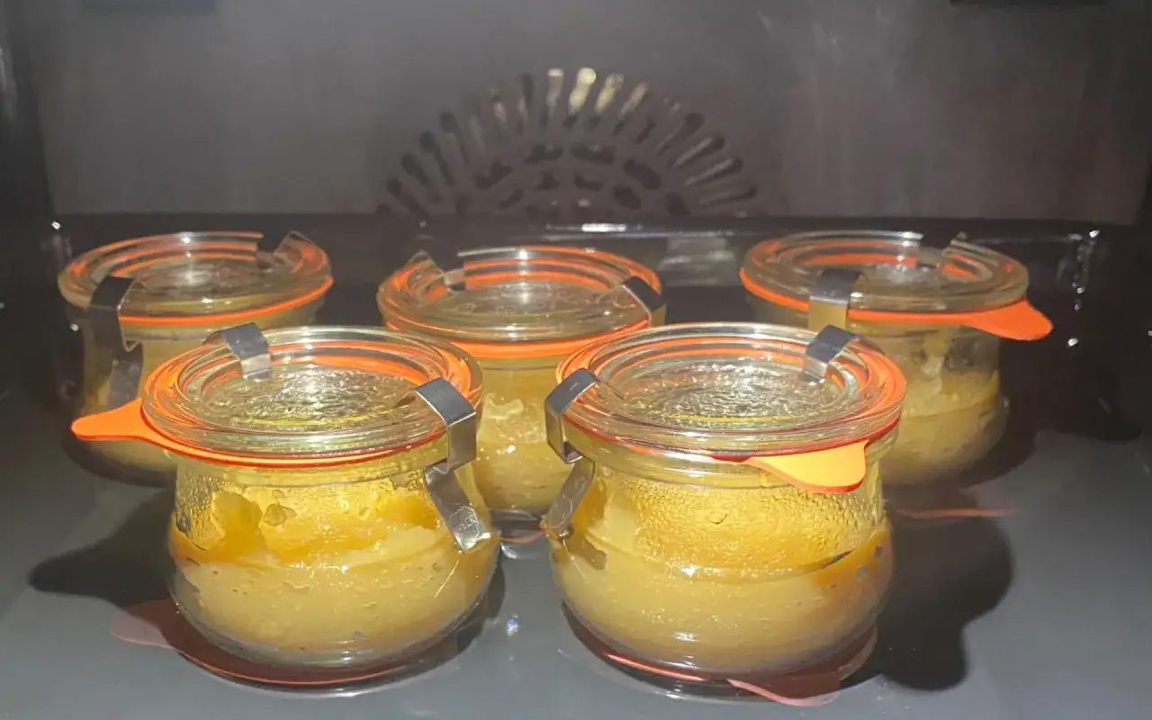 Fünf Gläser mit Apfelmus stehen im Backofen, bereit zum Einkochen.