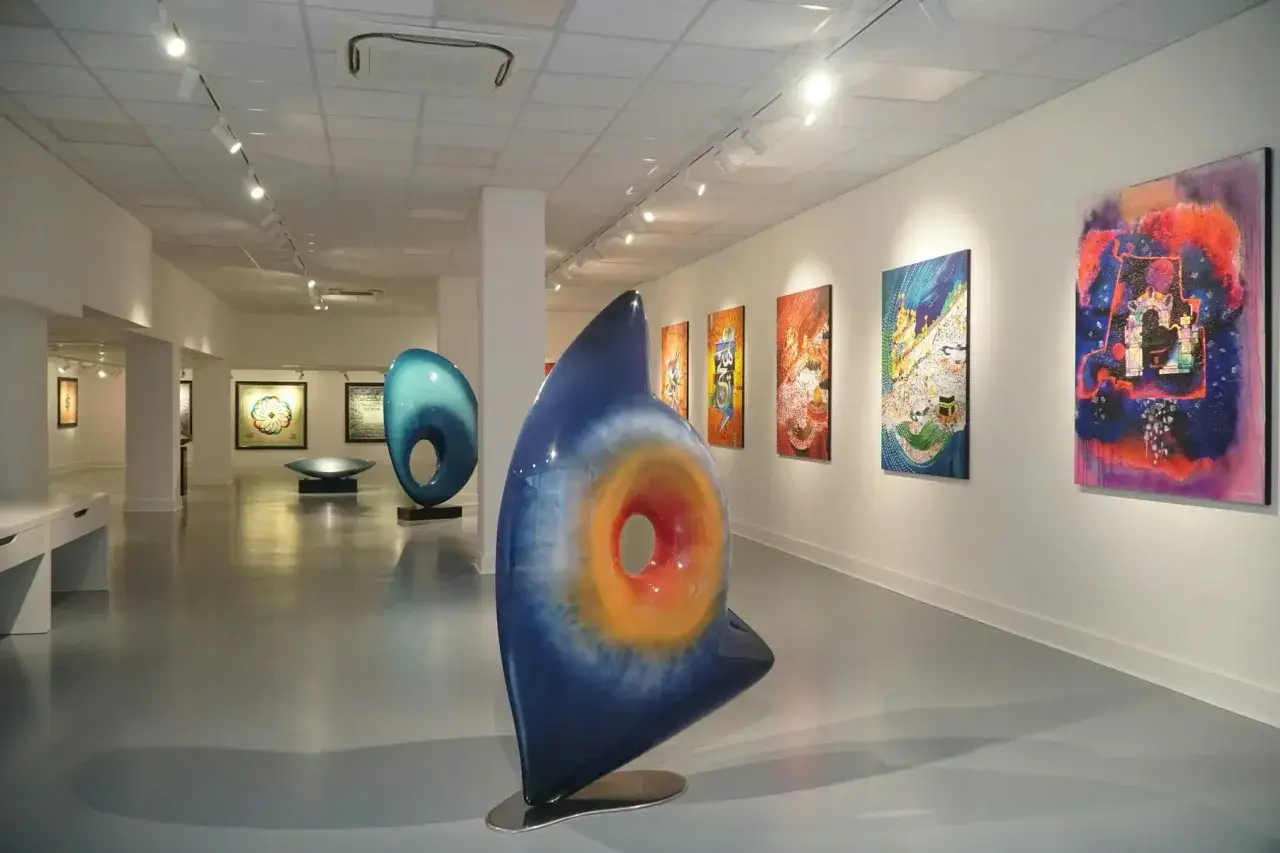 Vibrant sculptures and paintings fill a modern gallery space, hinting at the artistic vision of Saatchi Yates.