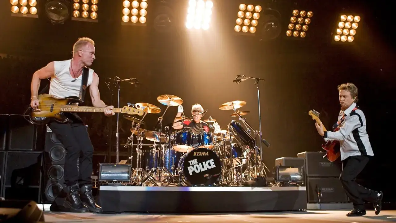 Sting gra na basie, Andy Summers na gitarze, a Stewart Copeland na perkusji podczas koncertu The Police.