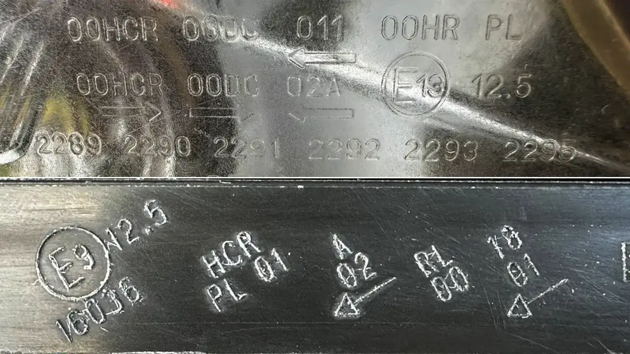 Oznaczenie lamp europejskich: wybite numery i symbole na metalowej powierzchni, w tym okrągłe znaki z literą