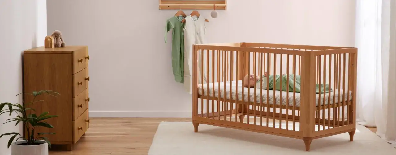 A baby sleeps soundly in a crib with a breathable mattress, a safe haven. Do breathable mattresses prevent SIDS? This nursery setup suggests a focus on safety.
