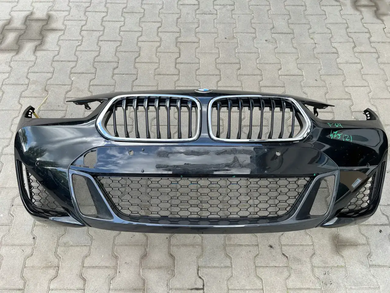 Czarna atrapa chłodnicy i zderzak BMW z pakietem M, gotowe do montażu.