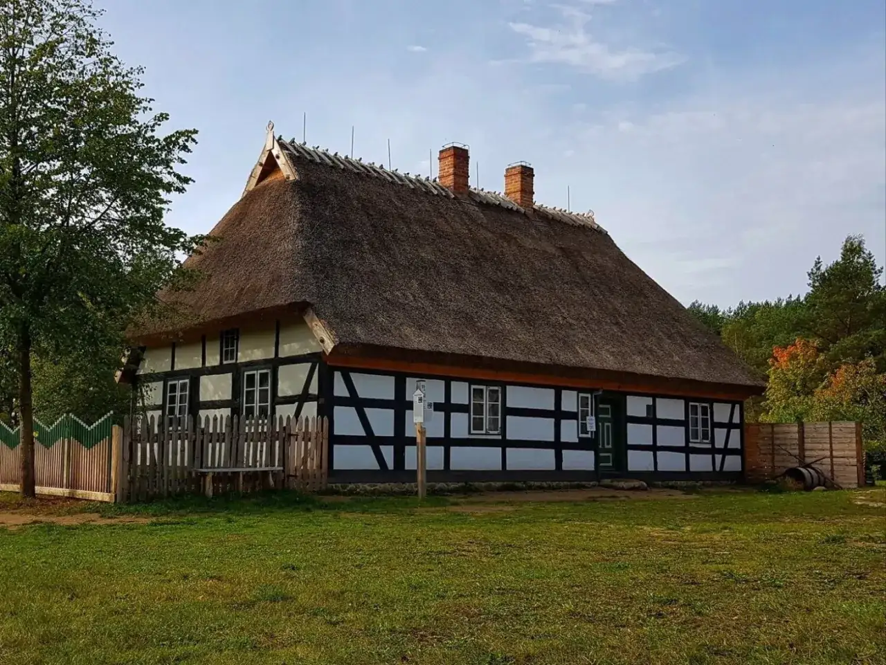 Tradycyjny dom z Wdzydz Kiszewskich, z charakterystycznym, krytym strzechą dachem i murami pruskimi.