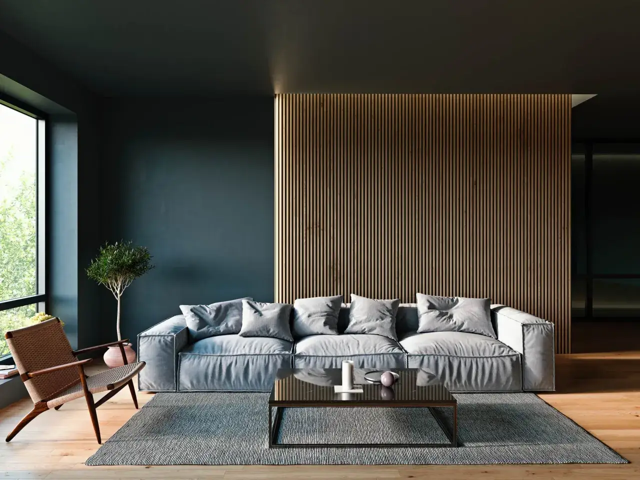 Gem&uuml;tliches Wohnzimmer mit einem gro&szlig;en grauen Sofa, einem Sessel und einem Couchtisch. Die moderne Wandgestaltung mit Holzlamellen schafft eine warme Atmosph&auml;re.