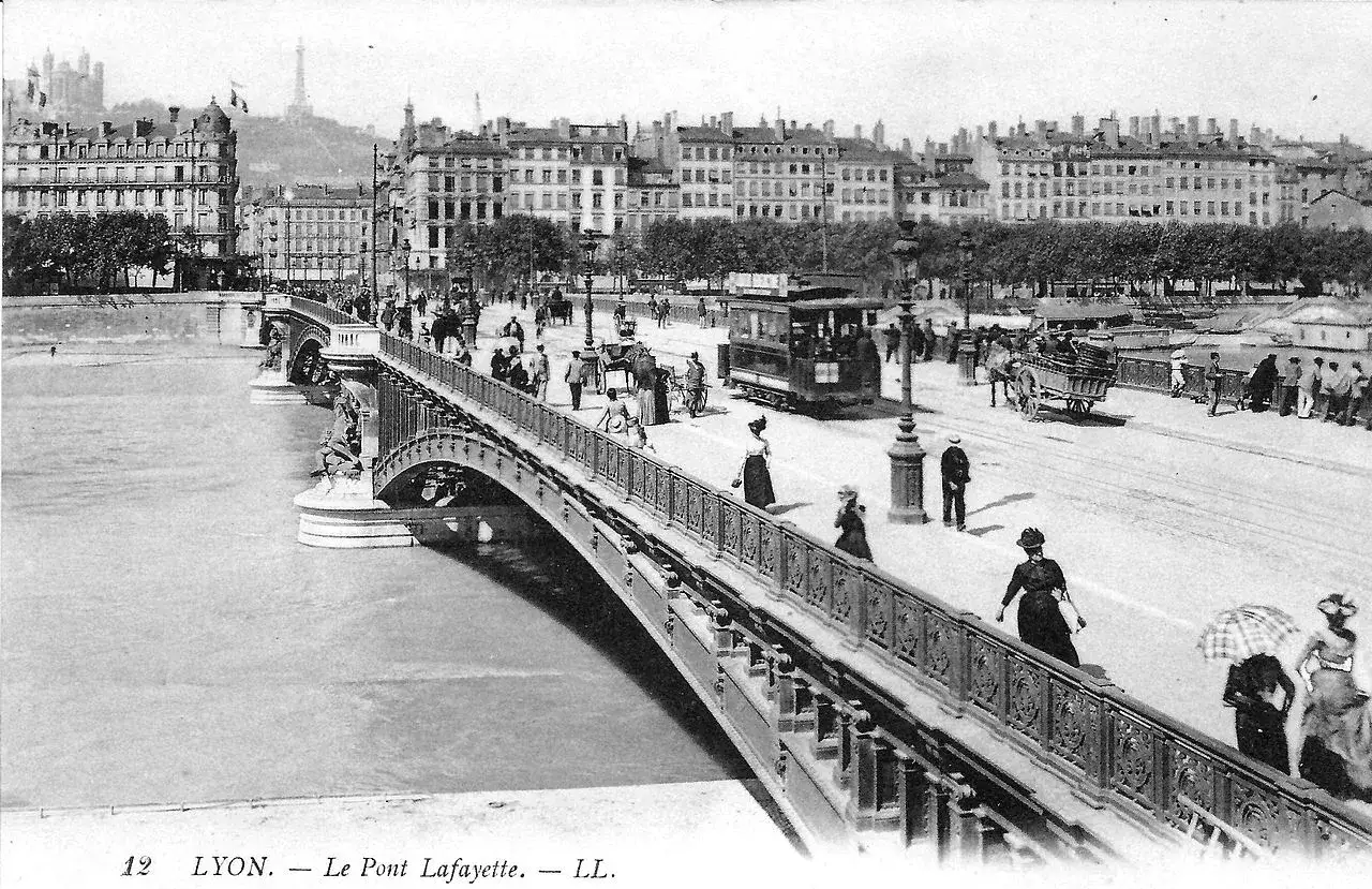 Vue anim&eacute;e du Pont Lafayette &agrave; Lyon, avec tramway, cal&egrave;ches et passants. La ville s'&eacute;tend au loin.