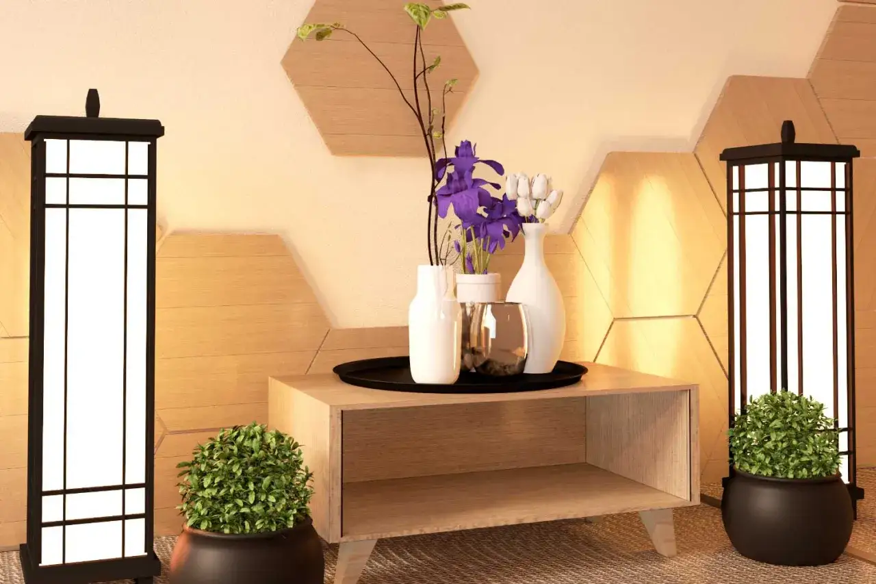 Dos l&aacute;mparas japonesas flanquean un mueble de madera con jarrones y flores. A los lados, dos peque&ntilde;as plantas que purifican el aire a&ntilde;aden vida.