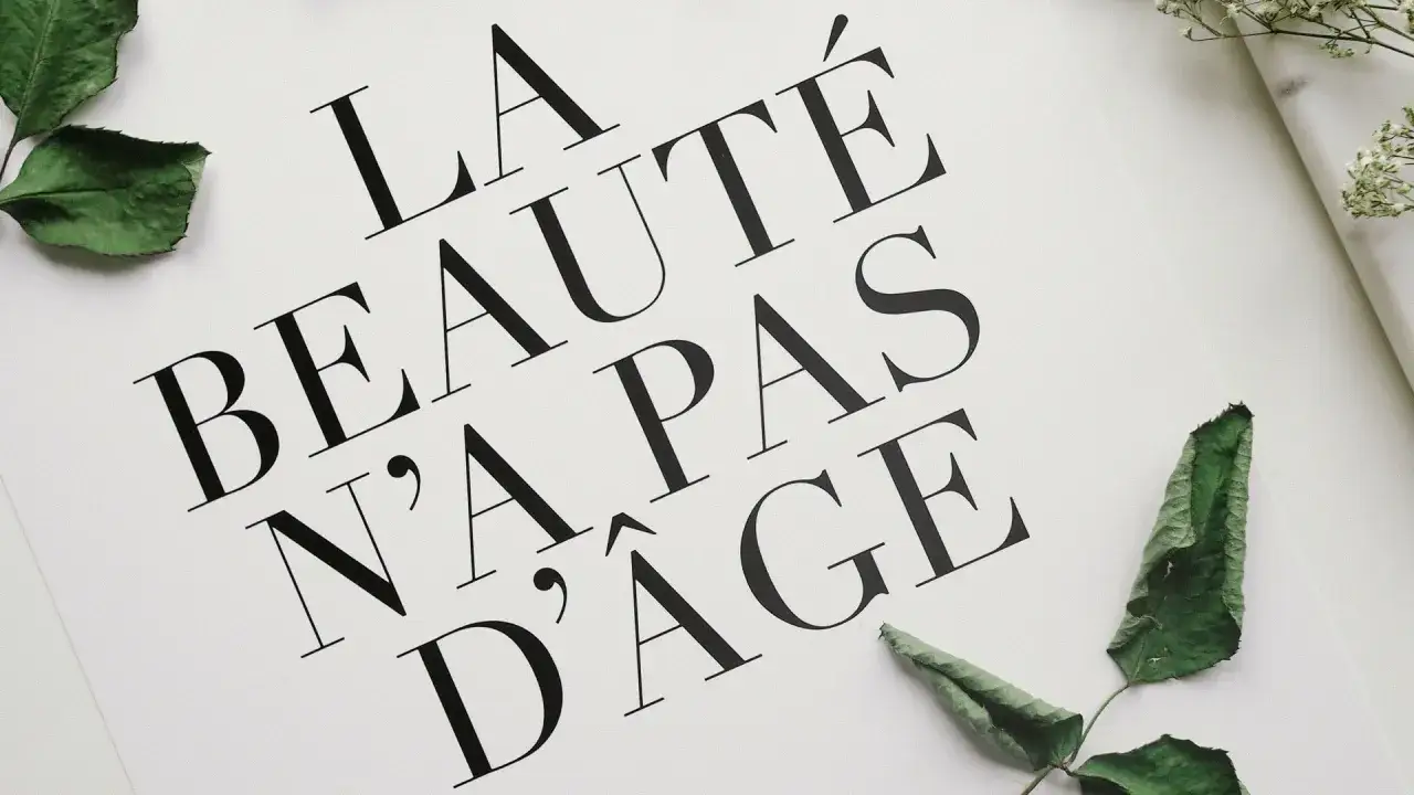 La belleza no tiene edad. Caligrafía bonita mayúsculas en un diseño elegante con hojas verdes.