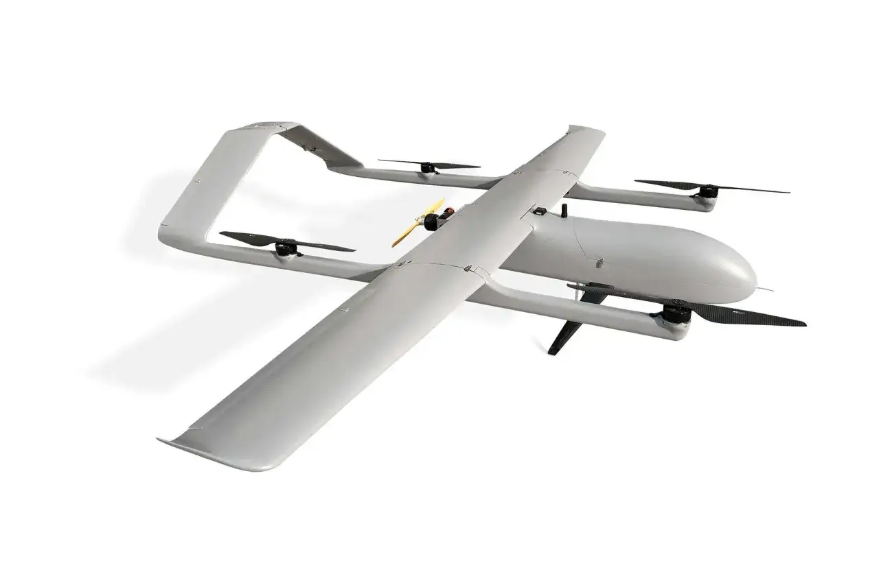 A sleek, gray vtol drone with four propellers and a distinctive wing design, ready for aerial missions.