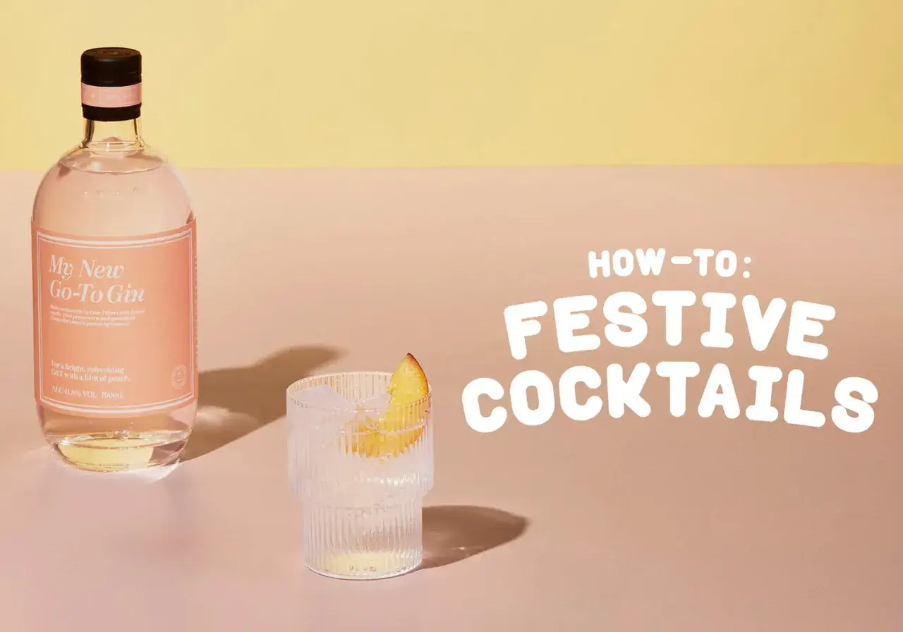 Orzeźwiający drink z likierem brzoskwiniowym, idealny na święta. Butelka ginu i szklanka z lodem i plasterkiem brzoskwini.