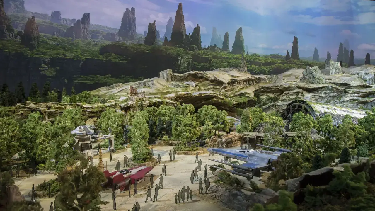 Un paisaje de **Disneyland Star Wars** con naves espaciales, figuras y monta&ntilde;as verdes.