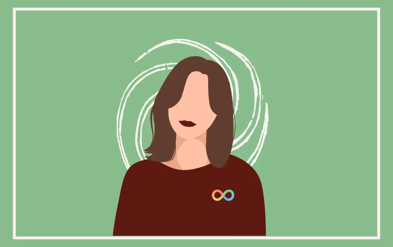 Een vrouw met een regenboogkleurig oneindigheidssymbool op haar trui, symbool voor autisme bij vrouwen.