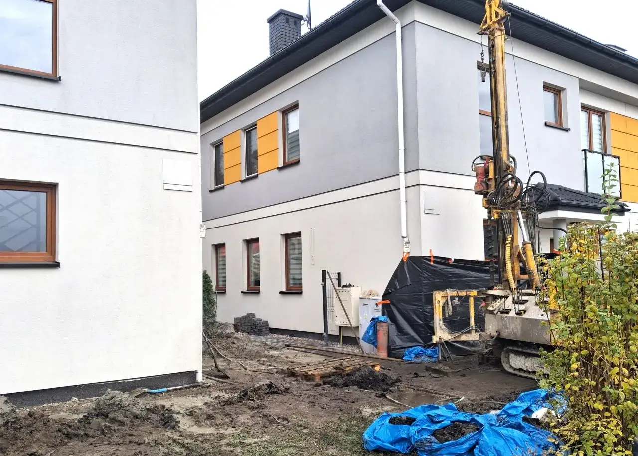 Maszyna wiertnicza na placu budowy. Zastanawiasz się, ile kosztuje ankrowanie domu?