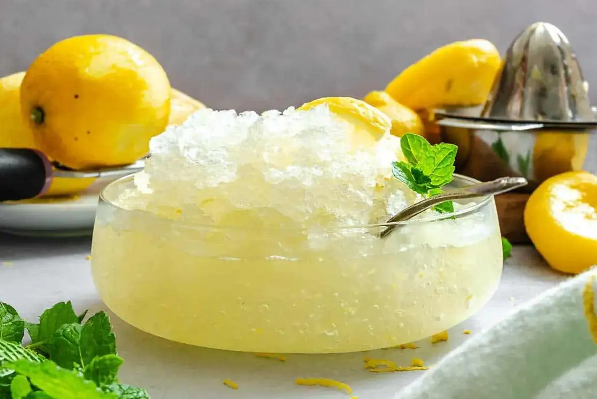 Erfrischendes Zitronen-Granita-Rezept, garniert mit Minze. Perfekt für heiße Tage!