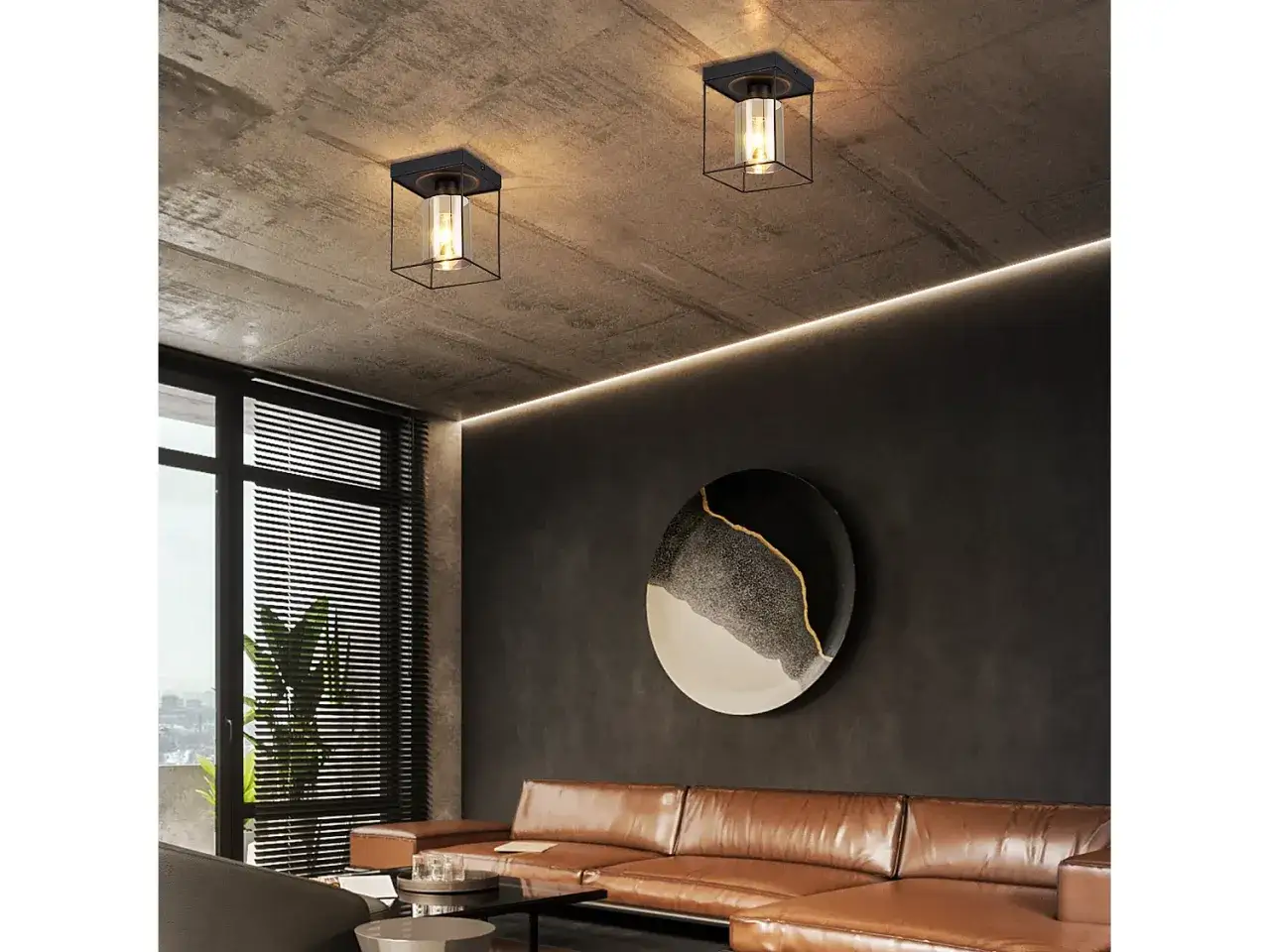 Dos lámparas rejilla de estilo industrial iluminan un techo de hormigón.