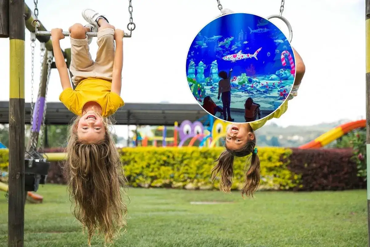 Dos ni&ntilde;as colgadas boca abajo de un columpio, con una imagen superpuesta de un acuario, ideal para disfrutar de Lisboa con ni&ntilde;os.